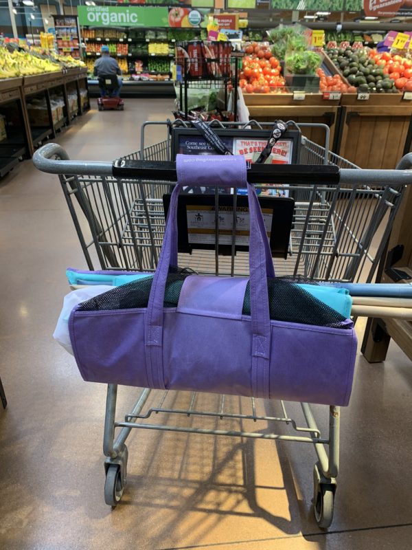 Lotus Trolley Bag hanging from grocery shopping cart